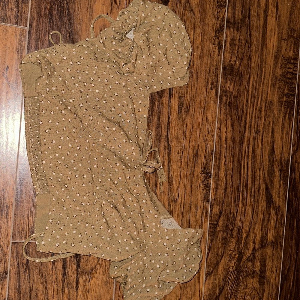 Brown crop top with small write flowers. Medium size.